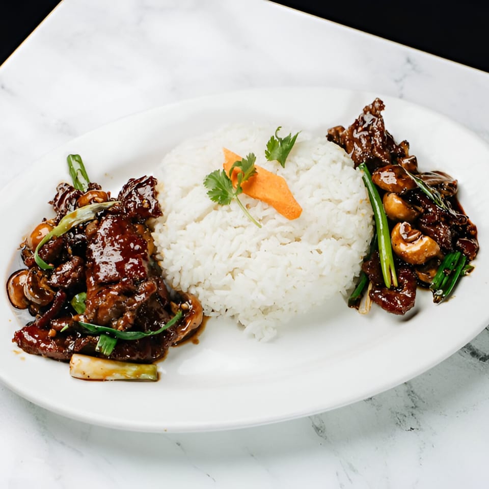 Vinsar's Lounge Asian-fusion beef and mushroom dish with white rice, garnished with carrot and cilantro.