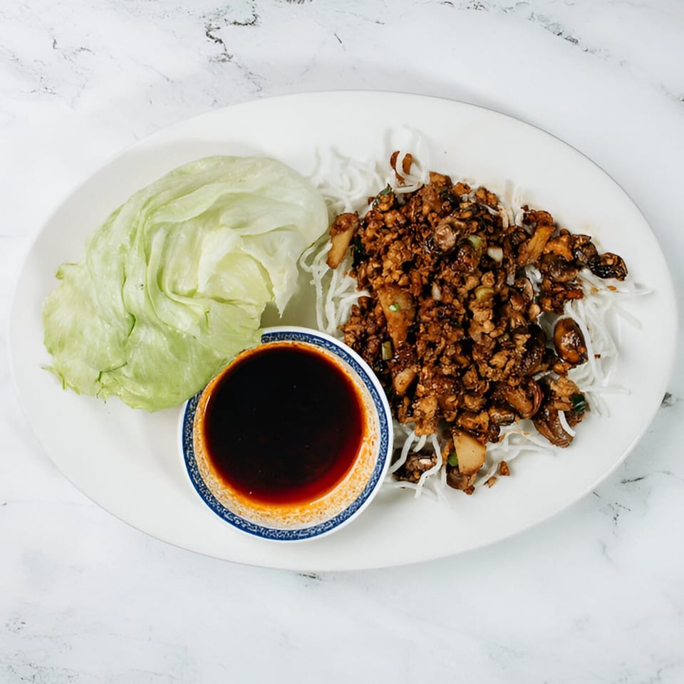 Vinsar's Lounge Asian-fusion lettuce wraps with minced meat, noodles, and dipping sauce.