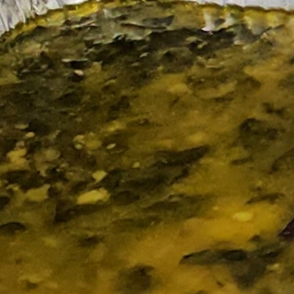 Close-up of a golden-brown, textured surface, possibly a baked good or casserole.
